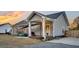 Backyard with a covered patio area featuring string lights, grill, and easy access into the home at 255 S Railroad Ave, Ridgeville, SC 29472