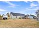 Spacious backyard with camper parked, back porch with grill and hot tub, offers ample outdoor enjoyment at 255 S Railroad Ave, Ridgeville, SC 29472