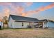 Spacious backyard showcasing a covered patio, ample lawn space, and privacy fencing, ideal for outdoor activities at 255 S Railroad Ave, Ridgeville, SC 29472