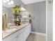 Bathroom featuring double sinks, granite countertops, modern fixtures, and patterned wallpaper at 255 S Railroad Ave, Ridgeville, SC 29472