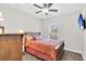 Comfortable bedroom featuring wood floors, warm lighting, and serene natural light from the window at 255 S Railroad Ave, Ridgeville, SC 29472