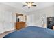 Bedroom with ceiling fan, ensuite bathroom access, and dresser with stylish mirror at 255 S Railroad Ave, Ridgeville, SC 29472