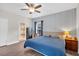 Relaxing bedroom featuring a blue quilt, stylish wallpaper, and a warm, inviting ambiance at 255 S Railroad Ave, Ridgeville, SC 29472