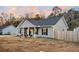 Charming single-story home featuring a welcoming front porch and well-maintained gray siding with a beautiful dusk sky at 255 S Railroad Ave, Ridgeville, SC 29472