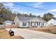 Well-maintained home with a long driveway, storage shed, and fenced yard at 255 S Railroad Ave, Ridgeville, SC 29472