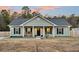 Inviting home exterior with rocking chairs and a manicured yard, creates a warm and welcoming curb appeal at 255 S Railroad Ave, Ridgeville, SC 29472