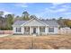 Charming single-story home with a welcoming front porch and rocking chairs at 255 S Railroad Ave, Ridgeville, SC 29472