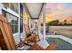 Cozy front porch area with rocking chairs, offering a relaxing outdoor space with a view of the neighborhood at 255 S Railroad Ave, Ridgeville, SC 29472