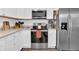 White kitchen with stainless steel appliances and granite countertops at 255 S Railroad Ave, Ridgeville, SC 29472