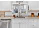 Close up on kitchen sink area with granite countertop and stainless appliances at 255 S Railroad Ave, Ridgeville, SC 29472