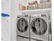 Modern laundry room featuring stainless steel washer and dryer with convenient shelving at 255 S Railroad Ave, Ridgeville, SC 29472