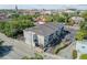 Aerial view of the complex with its gray roof, parking, surrounding trees, and nearby urban setting for great living at 259 E Bay St # 7C, Charleston, SC 29401