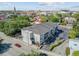 Aerial view of the apartment building showcasing its modern design, surrounding streets, mature trees and parking at 259 E Bay St # 7C, Charleston, SC 29401