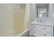 Clean bathroom featuring a white vanity with marble countertop and drawers, and a bathtub with shower at 259 E Bay St # 7C, Charleston, SC 29401
