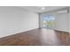 The room has dark wood floors and sliding glass doors with balcony access with light-colored walls that brighten the space at 259 E Bay St # 7C, Charleston, SC 29401
