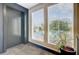 Hallway elevator with a window view and green plant at 259 E Bay St # 7C, Charleston, SC 29401