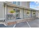 Apartment entrance features a cozy porch area with hanging plants and seating at 259 E Bay St # 7C, Charleston, SC 29401