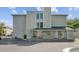 Apartment building entrance with covered walkway, potted plants, and painted parking spaces at 259 E Bay St # 7C, Charleston, SC 29401