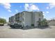 Multi-story building with parking, a truck, and balconies on a partly cloudy day at 259 E Bay St # 7C, Charleston, SC 29401