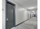 Long hallway with multiple doors and recessed lighting at 259 E Bay St # 7C, Charleston, SC 29401