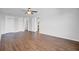 A large living room with dark wood floors and two closets, with doorways to the kitchen and bathroom creating an open layout at 259 E Bay St # 7C, Charleston, SC 29401