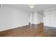 A spacious living room with dark wood flooring and multiple doorways with white trim, leading to other areas of the house at 259 E Bay St # 7C, Charleston, SC 29401