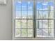 A bright window with exterior views and lush greenery, providing a calming atmosphere, and letting natural light flood the room at 259 E Bay St # 7C, Charleston, SC 29401