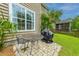 Backyard featuring an outdoor dining area, a grill, and beautiful landscaping at 3025 Buckeley Cir, Charleston, SC 29414