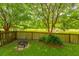 Cozy backyard area with fire pit, overlooking a peaceful pond and lush landscaping at 3025 Buckeley Cir, Charleston, SC 29414