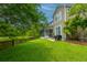 Serene backyard with screened porch overlooking lush greenery and a tranquil water feature at 3025 Buckeley Cir, Charleston, SC 29414