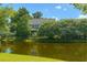 A charming home backs up to a serene pond with lush landscaping and mature trees for privacy and views at 3025 Buckeley Cir, Charleston, SC 29414