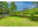 Picturesque backyard with a screened porch and a serene view of the pond and surrounding greenery at 3025 Buckeley Cir, Charleston, SC 29414