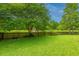 Tranquil backyard overlooking a scenic pond, surrounded by lush trees and foliage at 3025 Buckeley Cir, Charleston, SC 29414