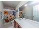 Bright bathroom featuring a floral shower curtain, a large mirror, and a white vanity with wood cabinets at 3025 Buckeley Cir, Charleston, SC 29414