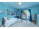 Inviting blue bedroom with a hanging chair, unique wall decor, and a comfortable bed near the window at 3025 Buckeley Cir, Charleston, SC 29414