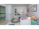 Well-lit bedroom with a colorful rug, playful decor, and a comfortable bed against white walls at 3025 Buckeley Cir, Charleston, SC 29414