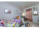 Charming bedroom with lilac walls, a playful bedspread, a vanity table, and a cozy rug at 3025 Buckeley Cir, Charleston, SC 29414
