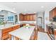 Well-lit kitchen featuring a center island, stainless steel appliances, and wood cabinets, opening to a living area at 3025 Buckeley Cir, Charleston, SC 29414