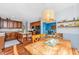 Open kitchen with wooden cabinets, an island with shelving, hardwood floors, and a view into another room at 3025 Buckeley Cir, Charleston, SC 29414