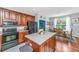 Spacious kitchen featuring an island, stainless steel appliances, wood cabinets, and hardwood floors, adjacent to the dining area at 3025 Buckeley Cir, Charleston, SC 29414