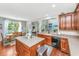 Open-concept kitchen with a center island, hardwood floors, and a view of the dining area with natural light at 3025 Buckeley Cir, Charleston, SC 29414