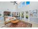 Open-concept living room with natural light showcasing the vaulted ceiling, large windows, and fireplace at 3025 Buckeley Cir, Charleston, SC 29414