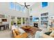 Spacious living room features tall windows, high ceiling, fireplace, and cozy seating area at 3025 Buckeley Cir, Charleston, SC 29414