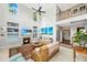 Bright living room boasts a fireplace, built-in shelving, and a soaring ceiling with fan at 3025 Buckeley Cir, Charleston, SC 29414