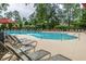 Community pool area with many lounge chairs and umbrellas for comfortable poolside relaxation at 3025 Buckeley Cir, Charleston, SC 29414