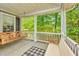 Relaxing porch with a hanging swing, white railing, and a view of the lush greenery at 3025 Buckeley Cir, Charleston, SC 29414
