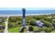 Breathtaking aerial view of the beach, surrounding property, and tall historic tower at 3030 Brownell, Sullivans Island, SC 29482