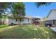 Spacious backyard with lush greenery and a charming screened porch, ideal for outdoor activities at 3050 Brigham Ct, North Charleston, SC 29406