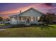 Charming single-story home featuring a cozy front porch, attached garage, and well-maintained lawn at 3050 Brigham Ct, North Charleston, SC 29406