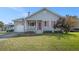 Charming single-story home featuring a cozy front porch, attached garage, and well-maintained lawn at 3050 Brigham Ct, North Charleston, SC 29406